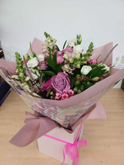 Pink and White Handtie - An elegant mix of pink and white flowers hand selected and delivered by the florist makes this the ideal gift for any occasion. Flowers may vary.