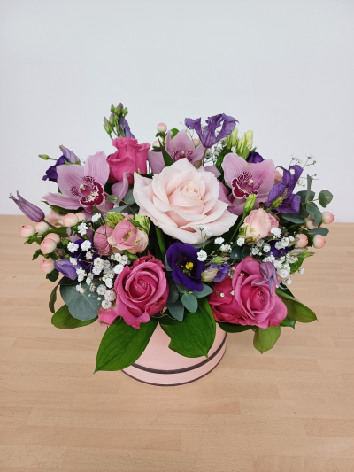 Pretty in Pink - A pretty arrangement in a hatbox featuring orchids and other pink flowers. Needs to be preordered to have the orchids in.
